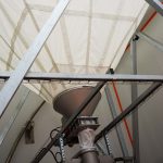 Vis de transfert à la base d'un silo souple textile
